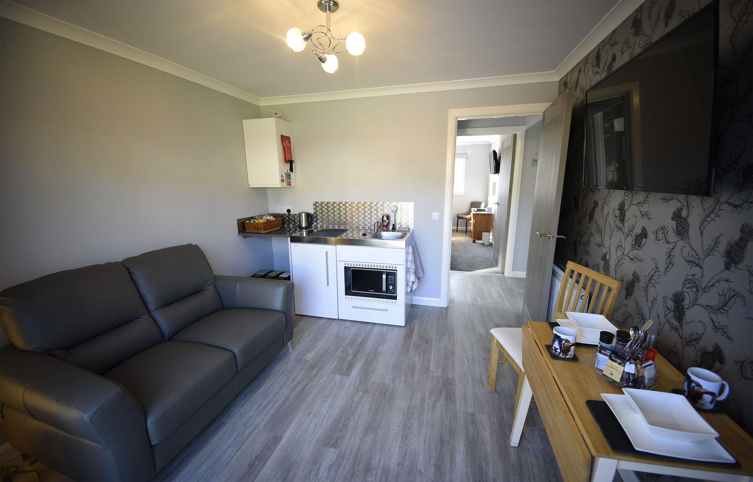 Relax in Taransay House Luxury Accommodation in Portree public seating area with woodburning stove